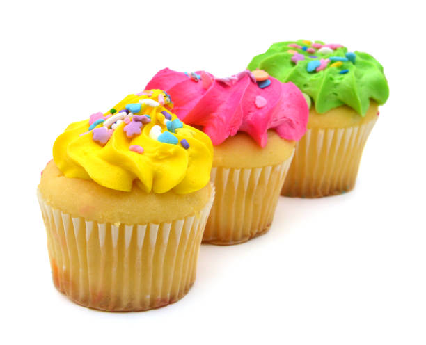 istock Stacked colorful cupcakes isolated over white background 981088700