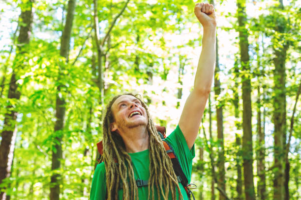 istock Happy hiker raising his hands in the air 981092006