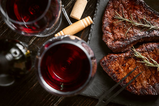 steaks from fresh meat dinner for two with steaks and red wine steak stock pictures, royalty-free photos & images