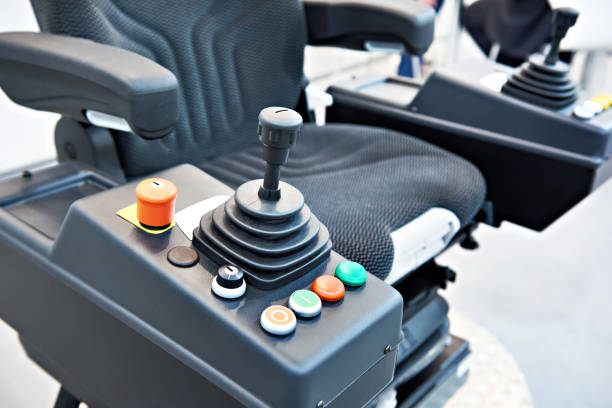 Joystick on seat for construction vehicle Joystick on driver seat for construction vehicle passenger cabin photos stock pictures, royalty-free photos & images