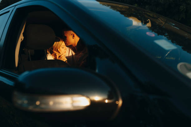 istock Man kissing woman on backseat 981097970