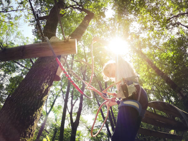 istock Young Girl Checking Rope Knot at Fun Park 981108678