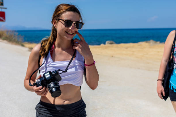 istock Young Woman Photographer on Beach 981116730