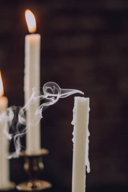 istock candles on candelabrum extinguished one smoke 981119696
