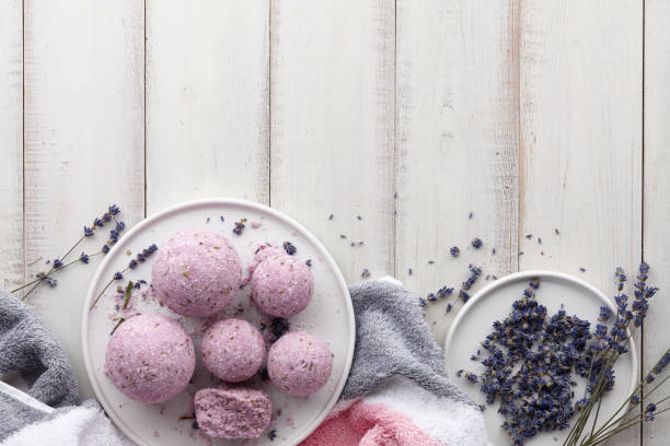 istock Handmade lavender bath bombs and flowers on white table 981120256