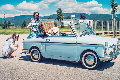 Two Mature Women With Broken Down Old-fashioned Car.