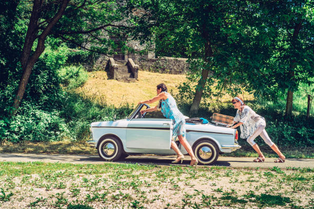  Chichester, England - September 14, 1991: A 1978-model Ford Escort driving on a stereotypical English country lane in late summer.