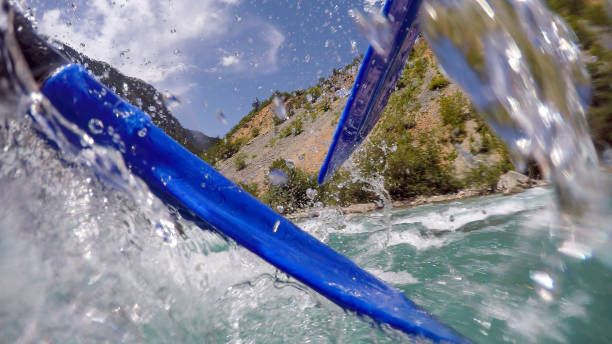 paddling through white water rapids - team sport rafting white water rafting rapid imagens e fotografias de stock