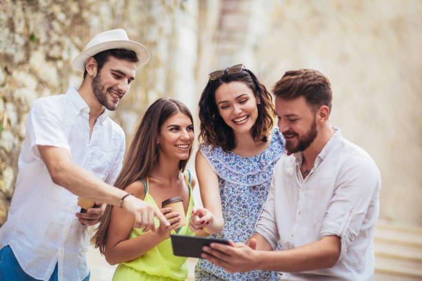 istock Group of young tourist friends with digital tablet having fun 981141414