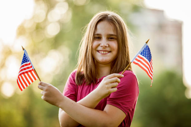 istock Young Girl with an American Flag 981168794