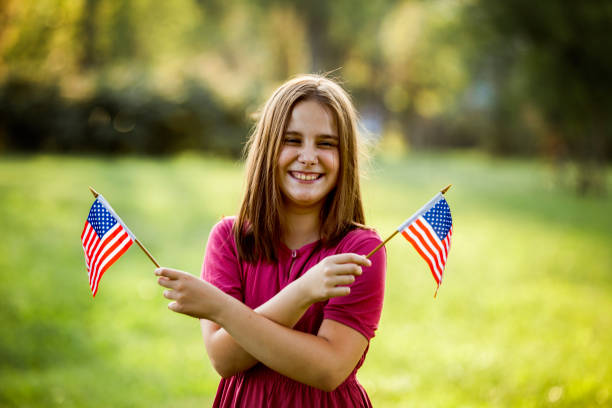 istock Young Girl with an American Flag 981168970