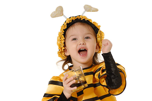 The little girl with a honey glass  bee costume stock pictures, royalty-free photos & images