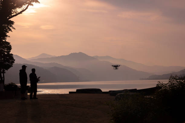 istock Drone Flying in The Sky with  lake and Mountain 981184836