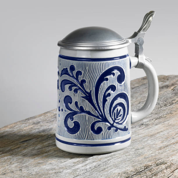 studio photography of a beer mug with metallic cap on wooden desk