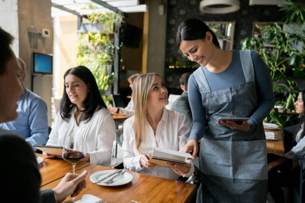 Waitress serving a group of people at a restaurant