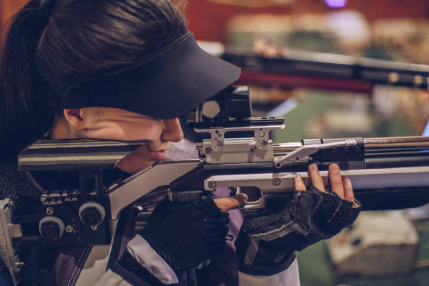 istock Pretty woman aiming at shooting range 981211856