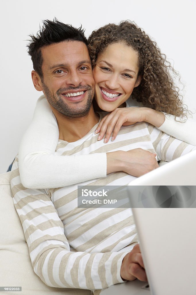 Portrait of a happy couple with laptop on sofa  Adult Stock Photo