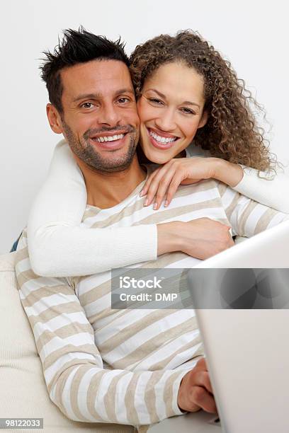 Portrait Of A Happy Couple With Laptop On Sofa Stock Photo - Download Image Now - Adult, Adults Only, Beautiful People