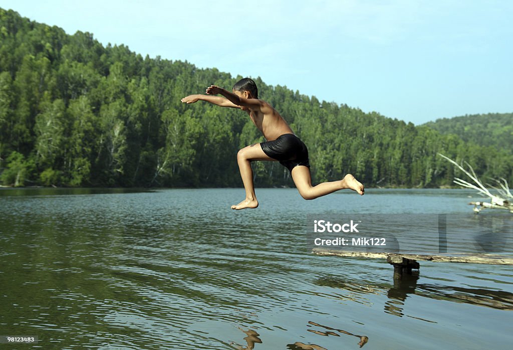 boy jumping in lake  Jumping Stock Photo