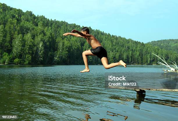 Boy Jumping In Lake Stock Photo - Download Image Now - Jumping, Lake, Boys