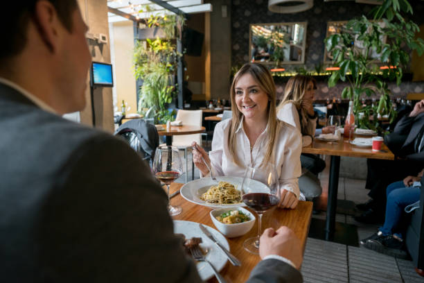 istock Happy couple on a date eating at a restaurant 981235942