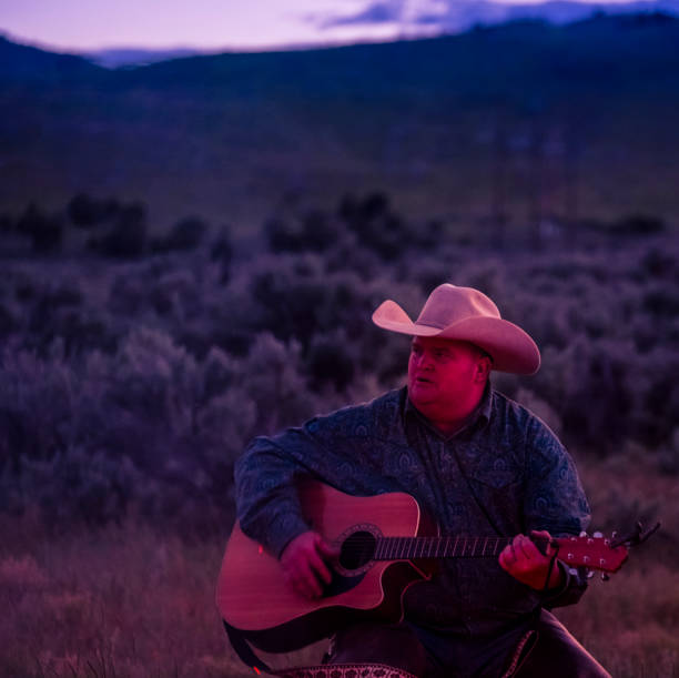 istock Western Family Having A Campfire And Sing Along 981250594