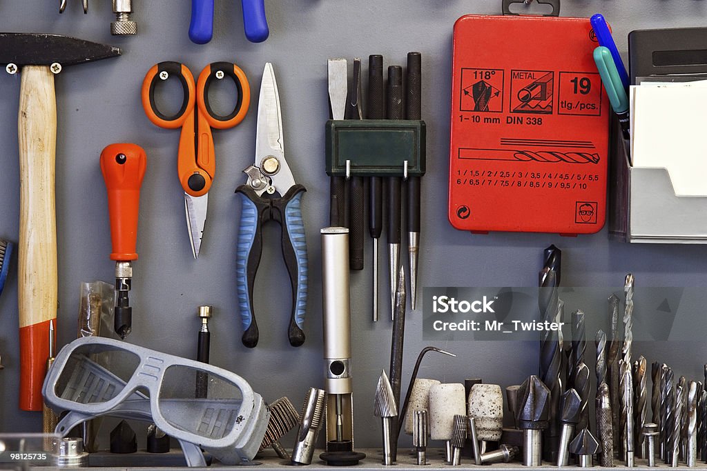 Set of tools Working tools are accurately located on a workshop wall Blue Stock Photo
