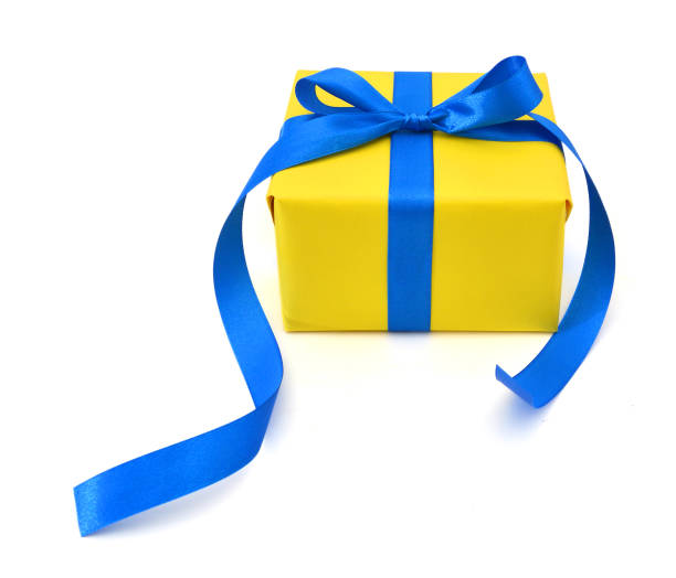 istock gift yellow box with blue ribbon bow close up isolated on white background 981286682