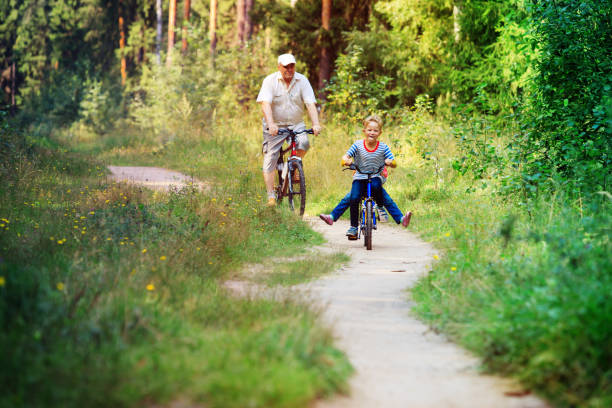 istock active senior with grandkids riding bikes in nature 981306530