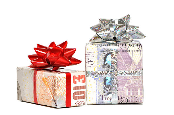 istock Two gift boxes wrapped with paper money and topped with bows 98130915