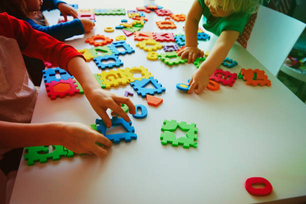 istock kids playing with number and shapes puzzle 981311462