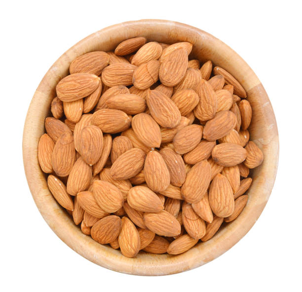 istock Almonds isolated on white background on wooden bowl 981311726