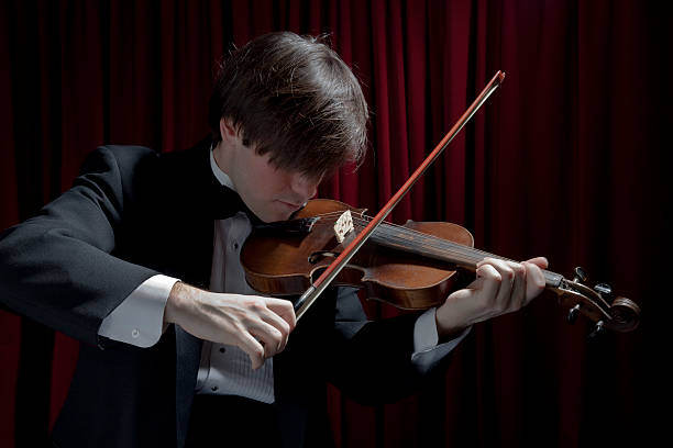 istock Young man in tuxedo playing violin 98131372