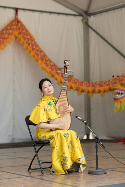 Columbus, Ohio, USA - May 27, 2018 A member of the Hefei Artists Group plays the pipa at the Asian Festival at the Franklin Park in Columbus, Ohio.