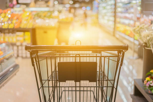 Abstract blurred photo of trolley in department store bokeh background,empty shopping cart in supermarket ,vintage color stock photo