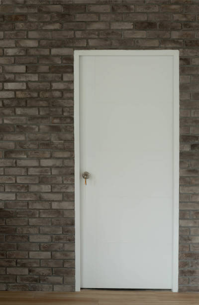 istock White room door On a vintage brick background. 981319330