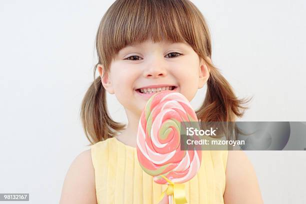 Young Girl With Swirled Pink Lolly Pop Stock Photo - Download Image Now - Beautiful People, Beauty, Candy
