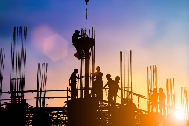 istock Silhouette of engineer and construction team working at site over blurred background sunset pastel for industry background with Light fair.Create from multiple reference images together. 981340140
