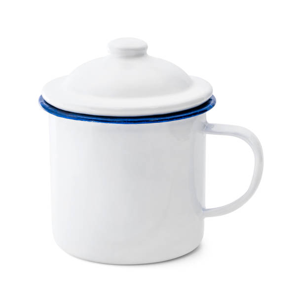 istock Blank enamel mug isolated on white background. Vintage cup made from tin material. ( Clipping path ) 981340180