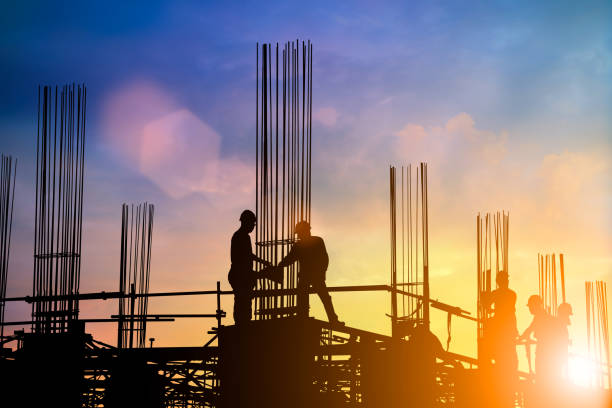 istock Silhouette of engineer and construction team working at site over blurred background sunset pastel for industry background with Light fair.Create from multiple reference images together. 981340666