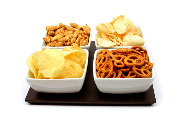 istock Pretzels, nuts and potato chips in four white bowls 98134300