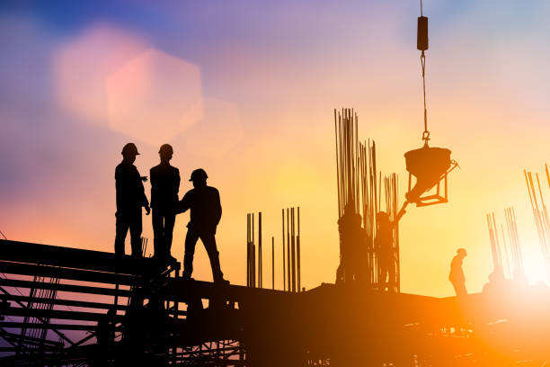 istock Silhouette of engineer and construction team working at site over blurred background sunset pastel for industry background with Light fair.Create from multiple reference images together. 981343536