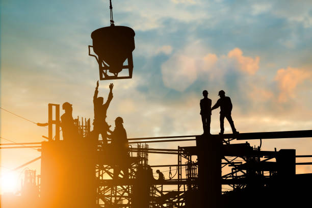 istock Silhouette of engineer and construction team working at site over blurred background sunset pastel for industry background with Light fair.Create from multiple reference images together. 981343984