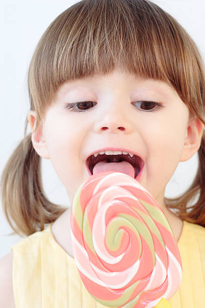 Girl and a lollipop stock photo