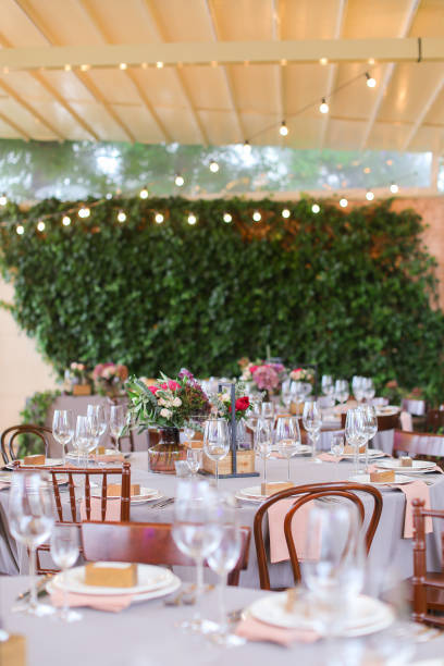 istock Decorated and served tables for banquet at restaurant in open air 981357448