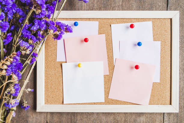 istock Blank notes on the cork board with dry flower bouquet 981376606
