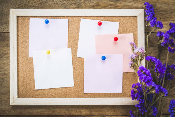 istock Blank notes on the cork board with dry flower bouquet 981378830