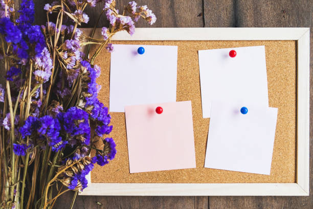 istock Blank notes on the cork board with dry flower bouquet 981379102