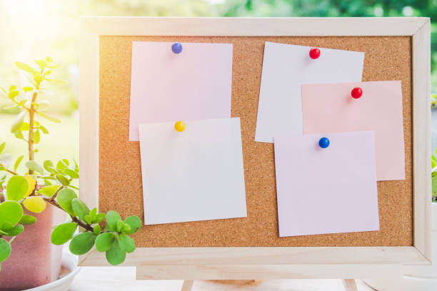 istock Sticky note on cork board with little tree,garden background 981379324