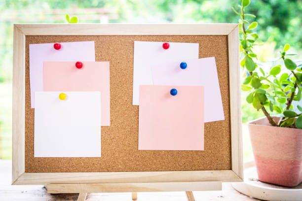 istock Sticky note on cork board with little tree,garden background 981379334